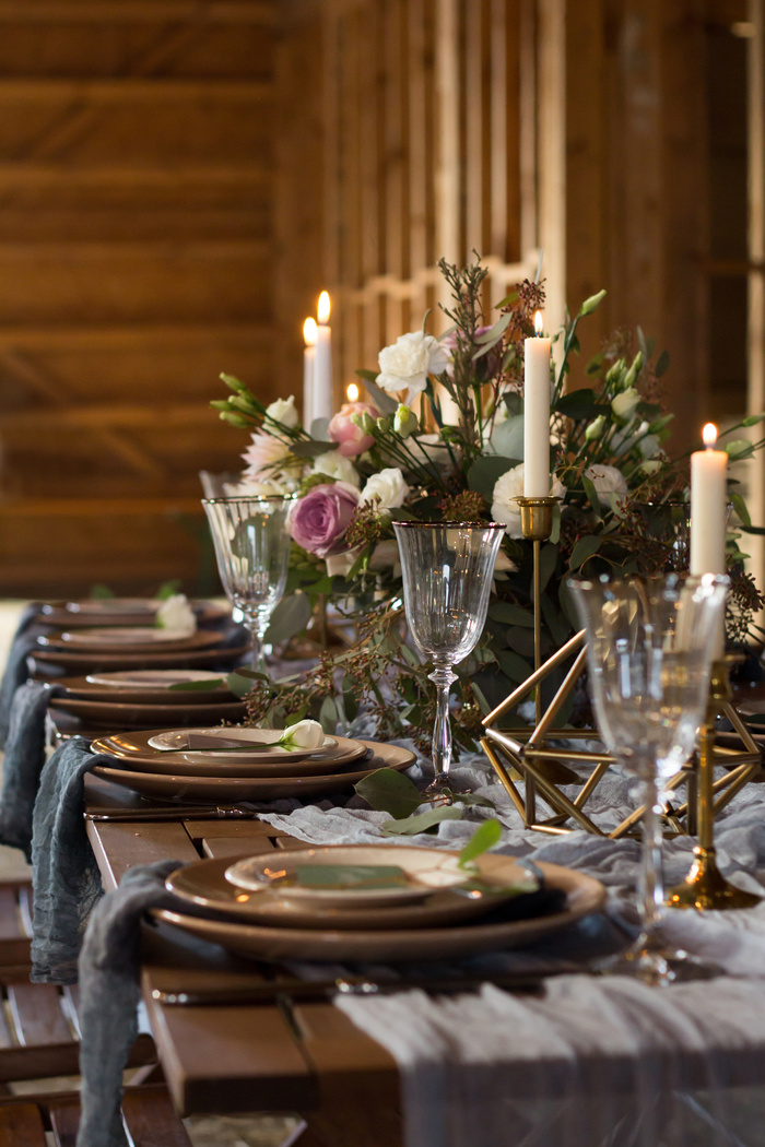 Laid Table By wedding banquet in a barn. Vertical.